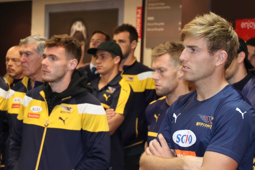 A group of West Coast Eagles players look on during Matt Priddis's press conference announcing his retirement.