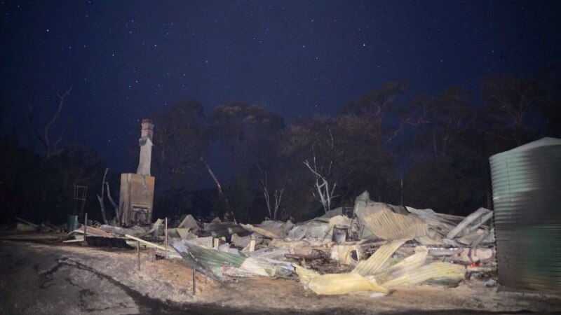 Metal and charred remains of a home destroyed in a bushfire at Crib Point.