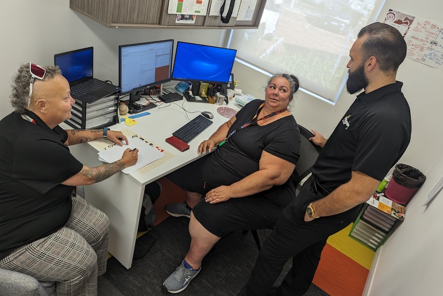 Jenny Bempasciuto, Leslee Skuse and Keiran Dent pictured talking around a desk at the Wungening office 