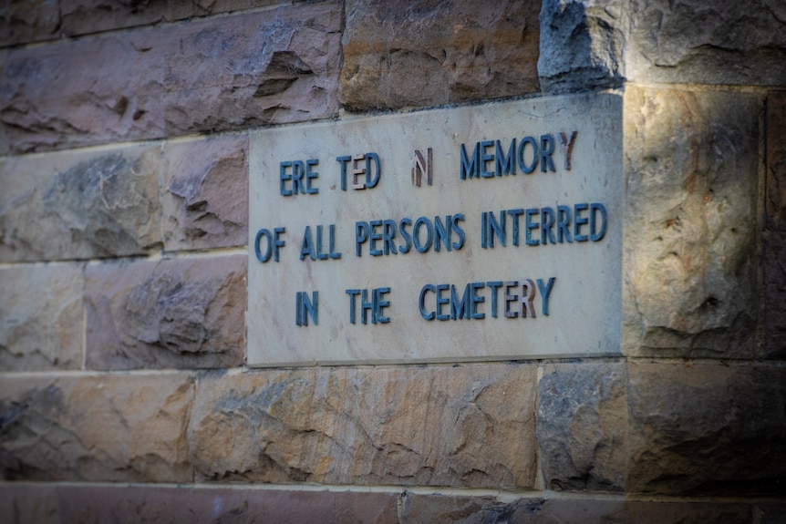 Plaque on a sandstone wall.