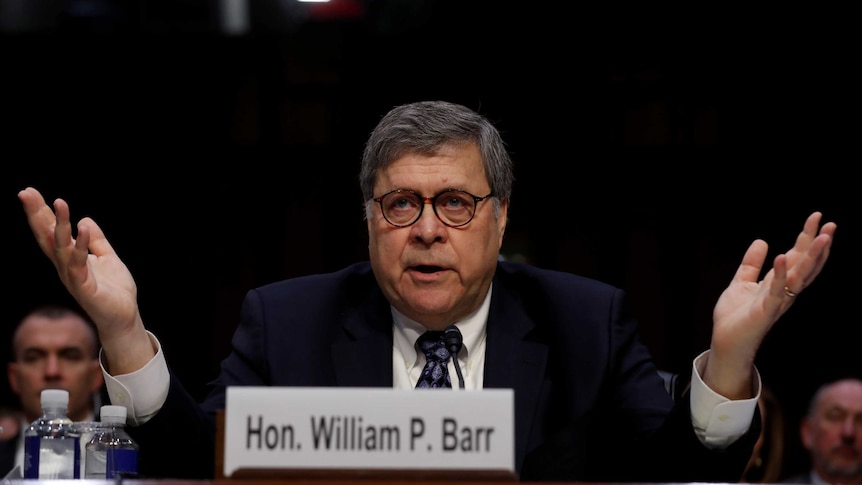 William Barr holds his hands up during his confirmation testimony.