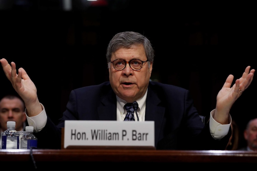 William Barr holds his hands up during his confirmation testimony.