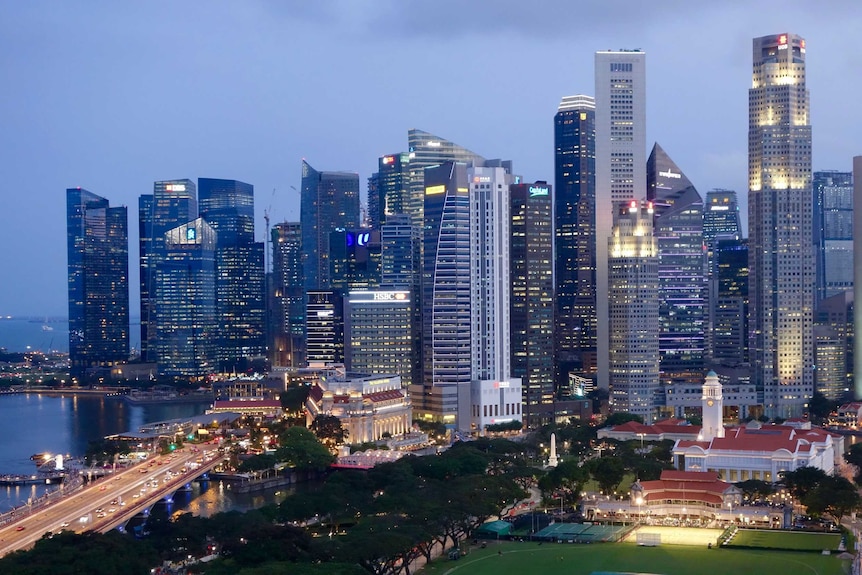 Bendras apšviestų pastatų vaizdas Singapūre.