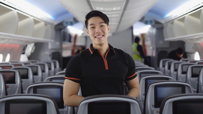 Pojchara Kosolchuenvijit on a plane in his Jetstar cabin crew uniform