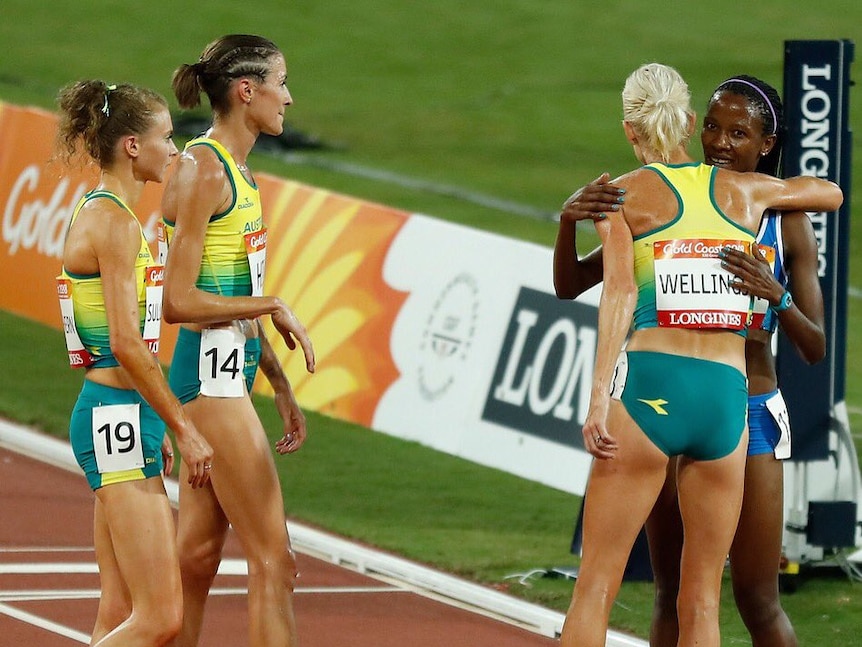 Celia Sullohern, Madeline Hills and Eloise Wellings congratulate Lineo Chaka.