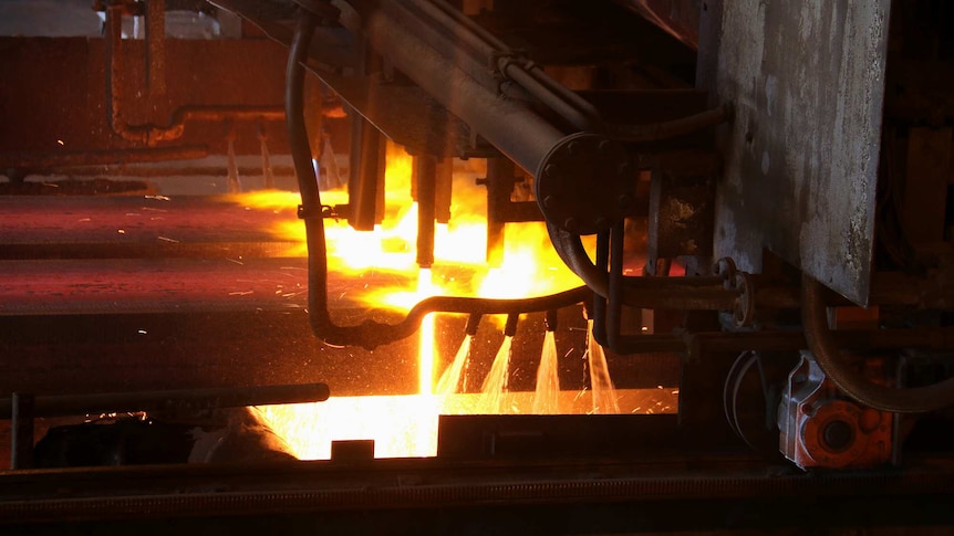 Molten steel shoots out of jets inside a steelworks factory.