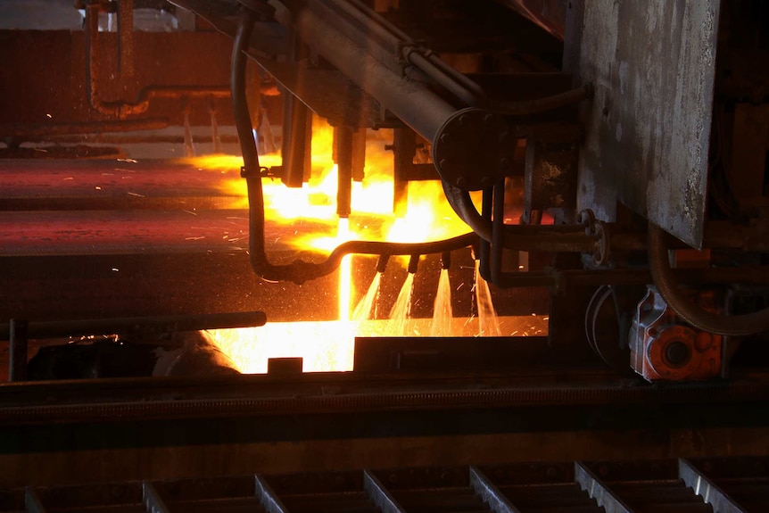 Molten steel shoots out of jets inside a steelworks factory.