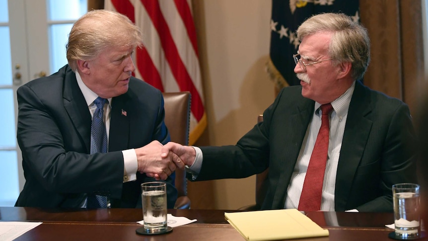 Donald Trump, left, shakes hands with John Bolton.