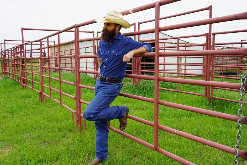 Brian Firebaugh leans against the gate of his cattle yards in central Texas