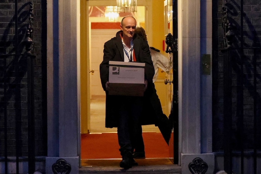 Dominic Cummings carries a box out of 10 Downing Street.