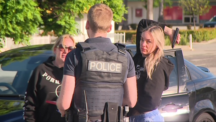 Amanda martin and another woman talk to police