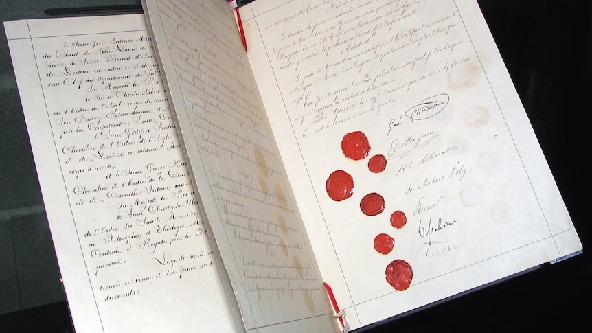 Geneva Convention booklet with wax seals and signatures on open page.