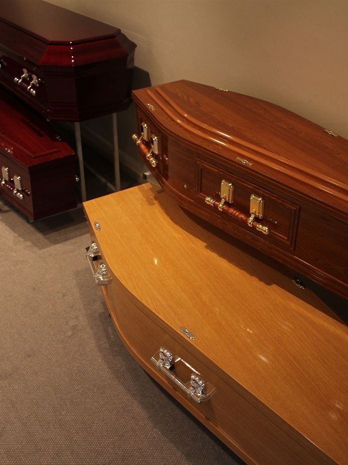 A regular-sized coffin sitting on top of a larger one.