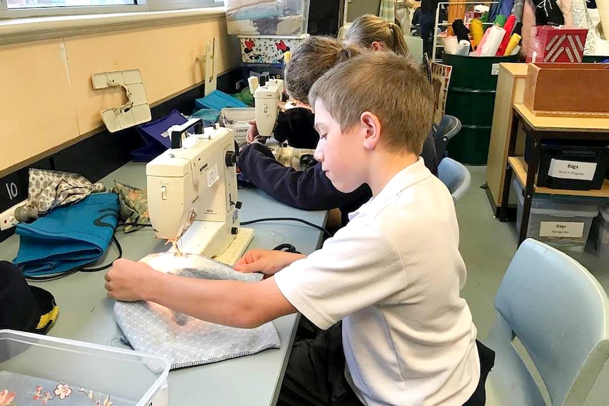 A classroom where teachers or mentors guide students to sew sanitary packs.