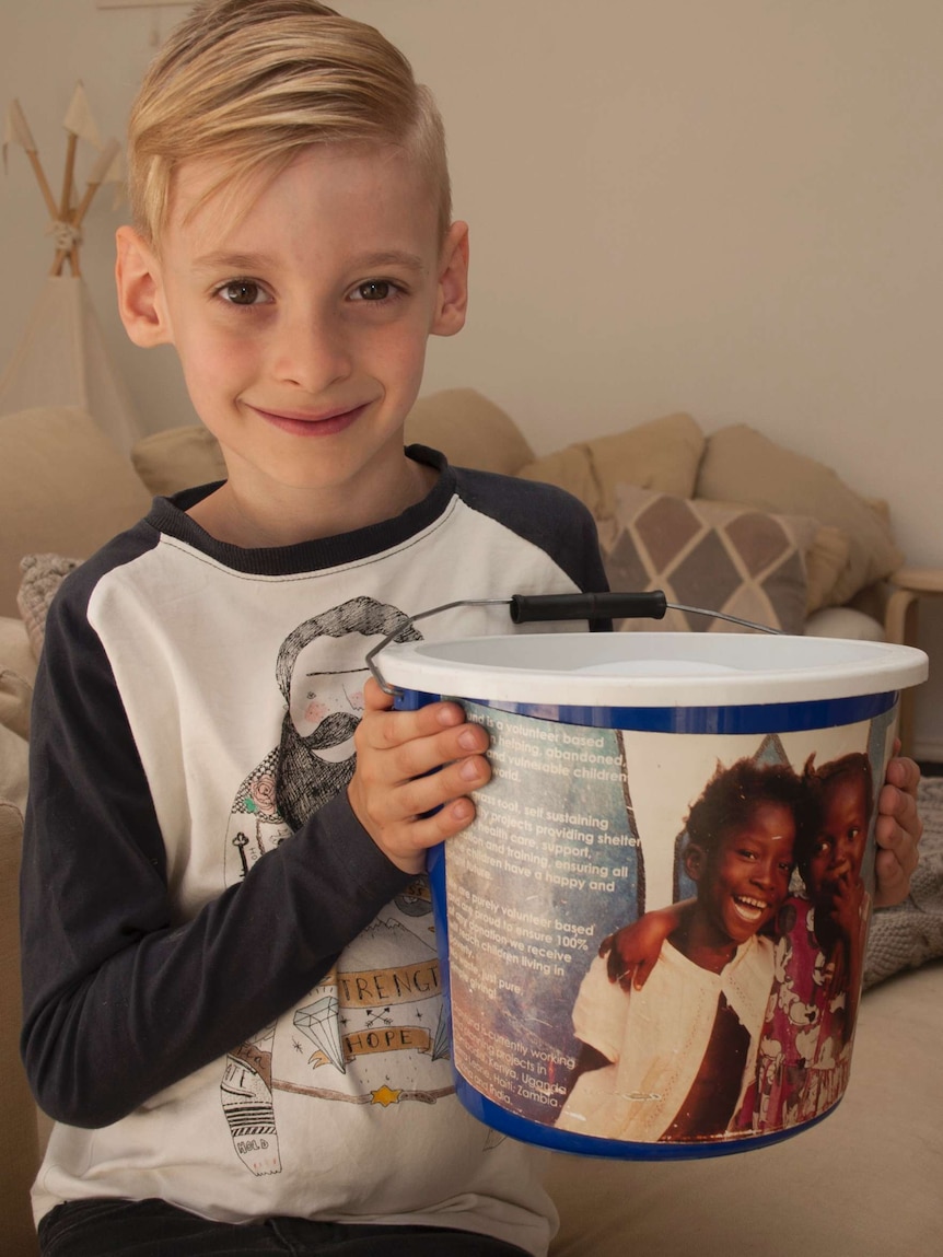 Cael Fay rattling the OrphFund donation bucket.