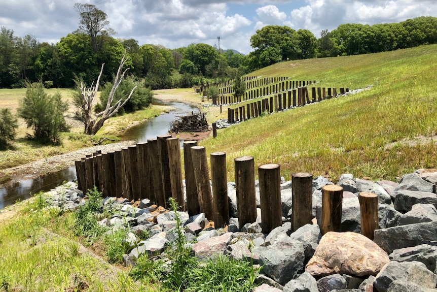 The drastically changed view downstream showing the wooden piles and rock.