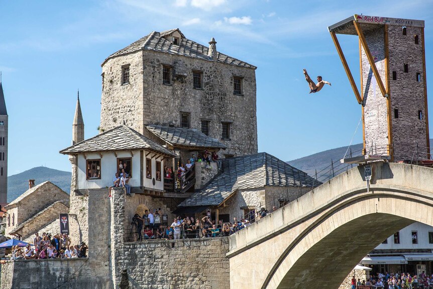 David Colturi of the US dives from the 27.5 metre platform on Stari Most as people watch.