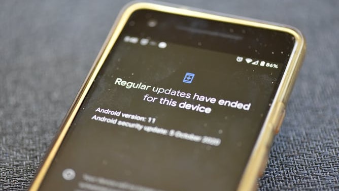 A phone screen with the error message "regular updates have ended for this device"