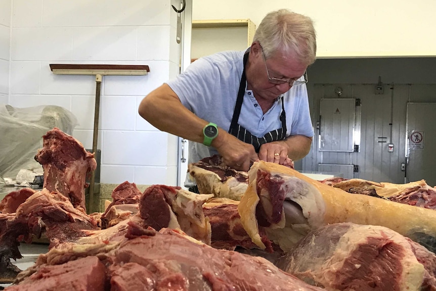 Chef Jens Steffen cuts meat at Abingdon Downs station.