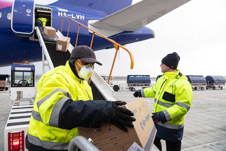 Boxes of medical aid and protective gear sent by China is unloaded from a plane in Hungary.