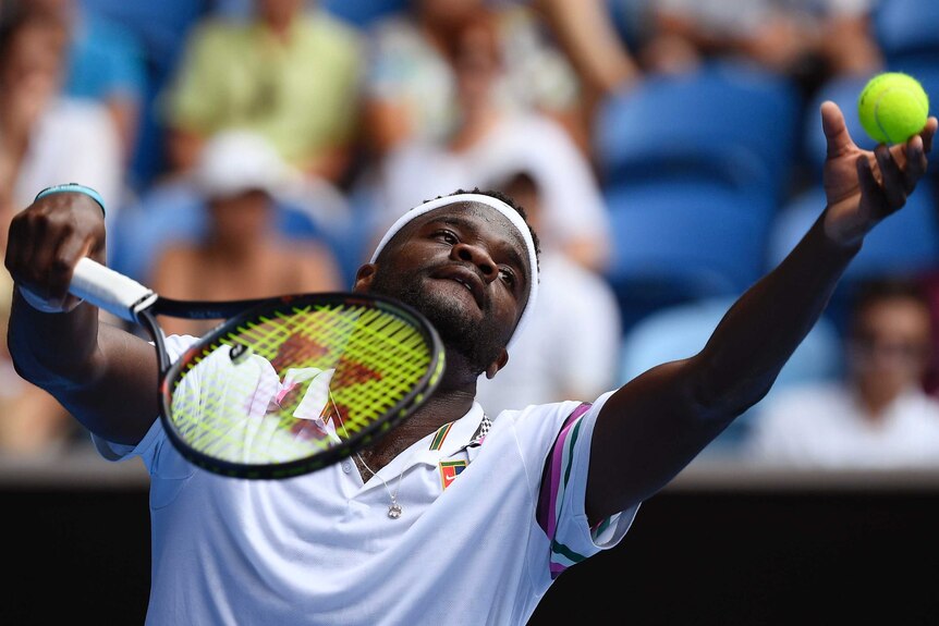 Frances Tiafoe serves to Kevin Anderson during his upset win.