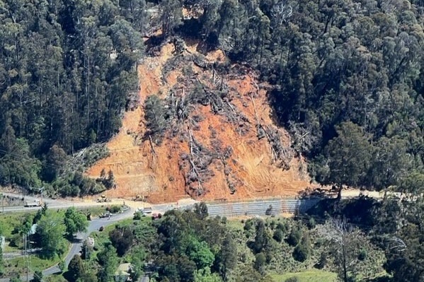 A landslide down a mountain viewed from up above.