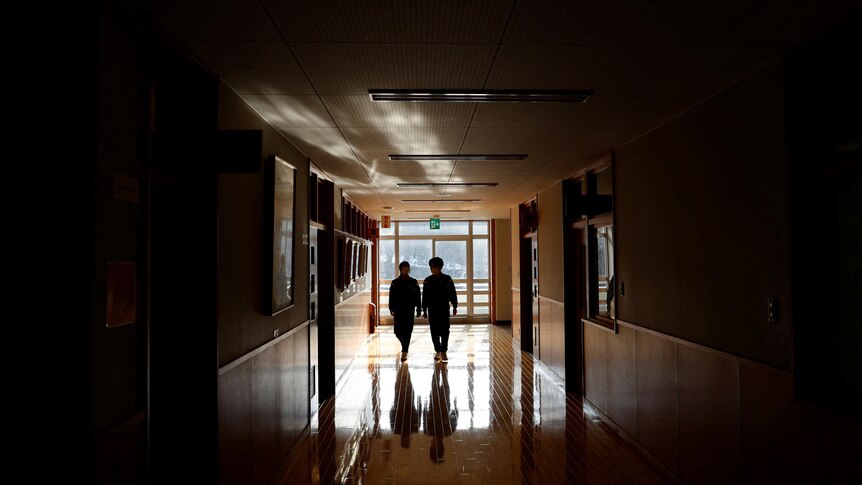 Eita Sato and Aoi Hoshi walk along the corridors of Yumoto Junior High School