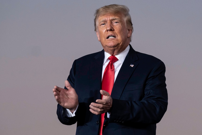 Former President Donald Trump prepares to take the stage during a rally.