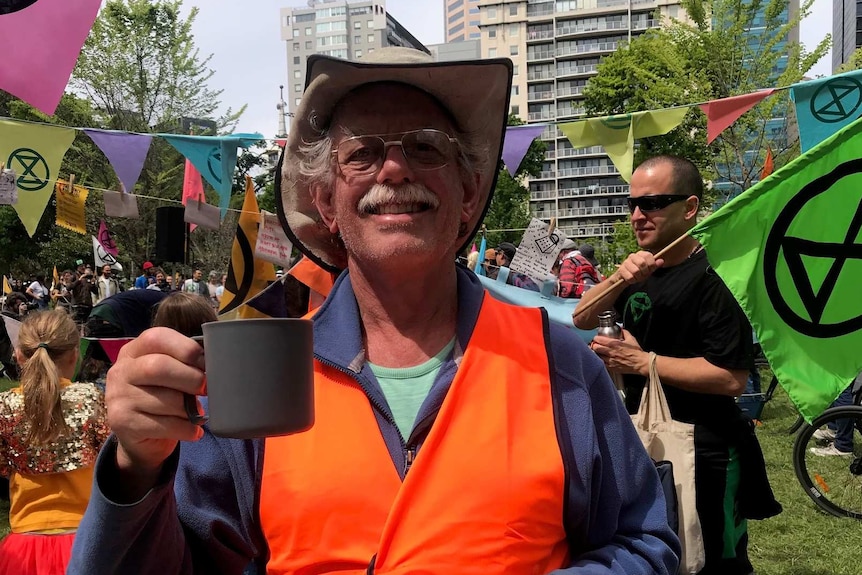 Alan Cuthbertson holds a cup of tea at Carlton Gardens with climate change protesters on October 13, 2019.