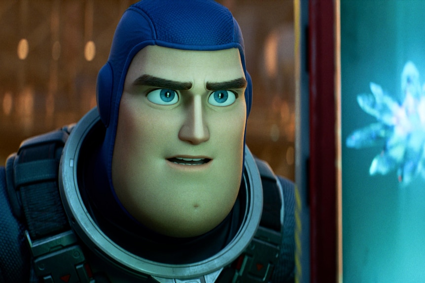 A still from the new Lightyear film showing Buzz Lightyear looking at a light