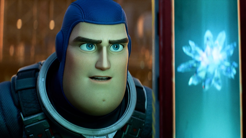 A still from the new Lightyear film showing Buzz Lightyear looking at a light