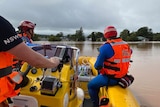 men inside a rubber boat on flooded waters