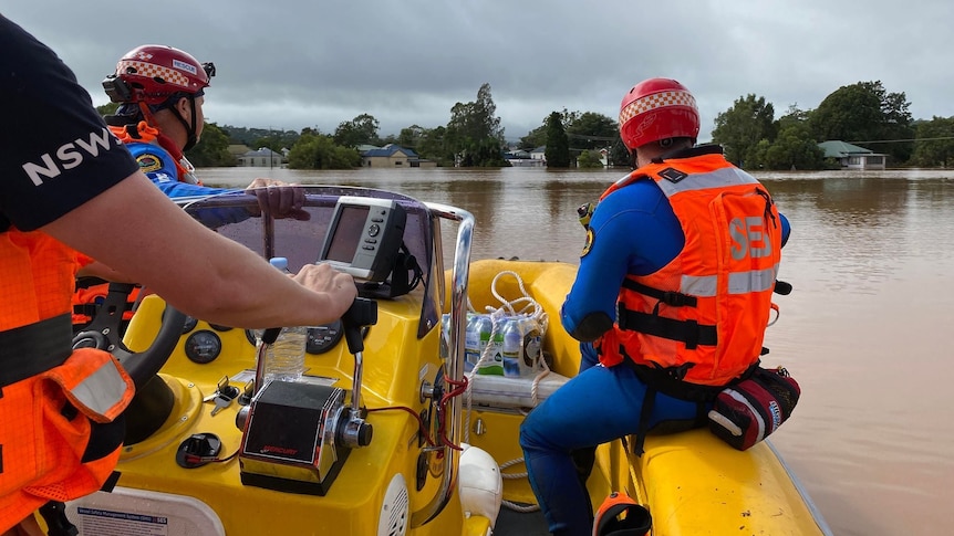 men inside a rubber boat on flooded waters