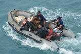 Indonesian navy divers on a motor boat in the Java Sea