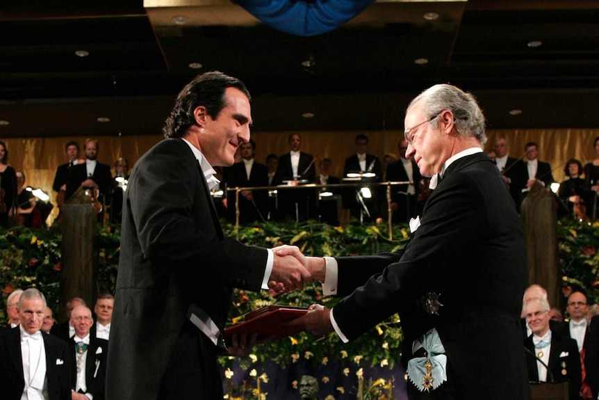 Professor Craig Mello accepting his Nobel Prize award during a ceremony.