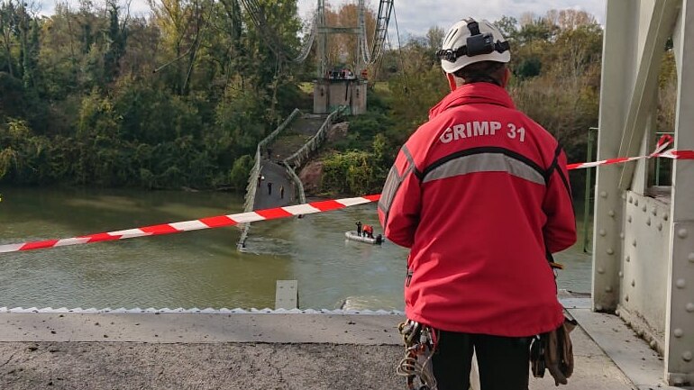 A firefighter examines the scene of the collapsed bridge.