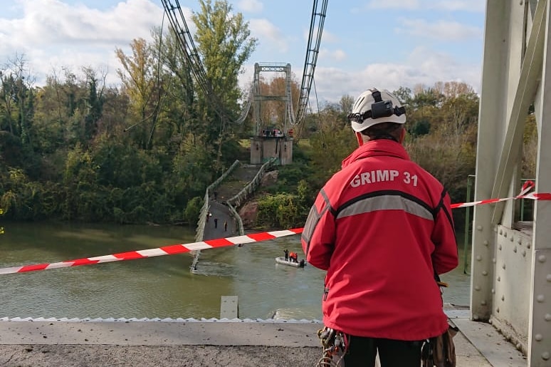 A firefighter examines the scene of the collapsed bridge.