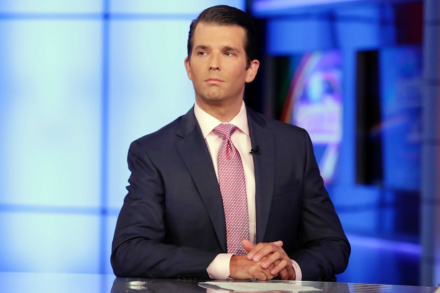 Donald Trump Jr in Fox News studio looking confident with TV lights behind him