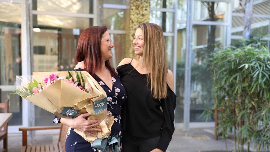 Kellie Brookes standing with her mother Dianne, who won Barnados 2018 ACT Mother of the year