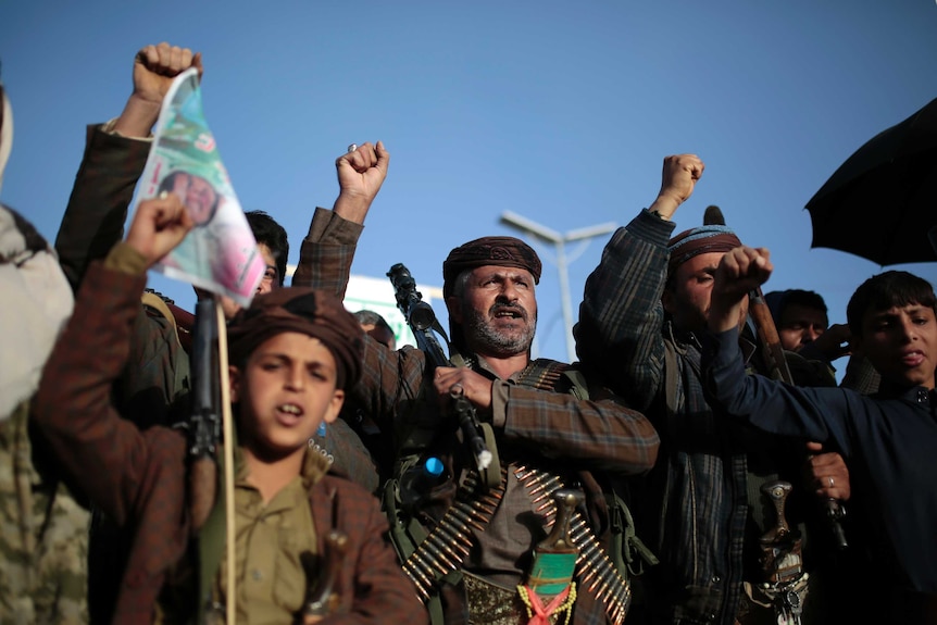 Houthi supporters in traditional attire stage a protest