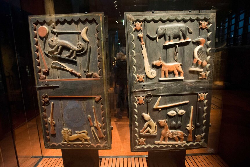 an artwork with carvings of animals and instruments