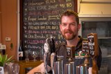 Micro brewer Nick Galton-Fenzi standing at his bar in the back blocks of Kalgoorlie-Boulder.