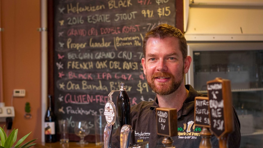 Micro brewer Nick Galton-Fenzi standing at his bar in the back blocks of Kalgoorlie-Boulder.