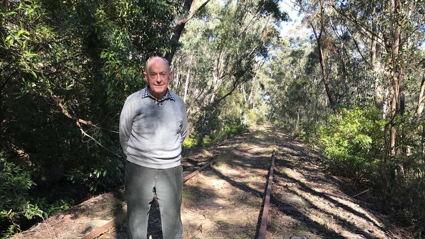 David Thurlow stands on the disused track that would be the rail trail.