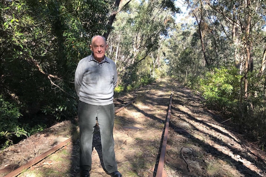David Thurlow stands on the disused track that would be the rail trail.