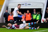 Spurs' Harry Kane shoots past Alan Hutton of Aston Villa to score at Villa Park on March 13, 2016.
