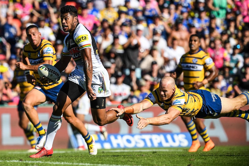 Waqa Blake (left) of the Panthers runs to score a try against Parramatta in NRL round 1, 2018.