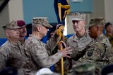 Former NATO commander US General John Allen hands over a flag to US General Joseph Dunford.
