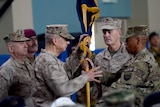 Former NATO commander US General John Allen hands over a flag to US General Joseph Dunford.