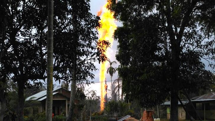 Fire burns high into the air during fire at oil well in Indonesia